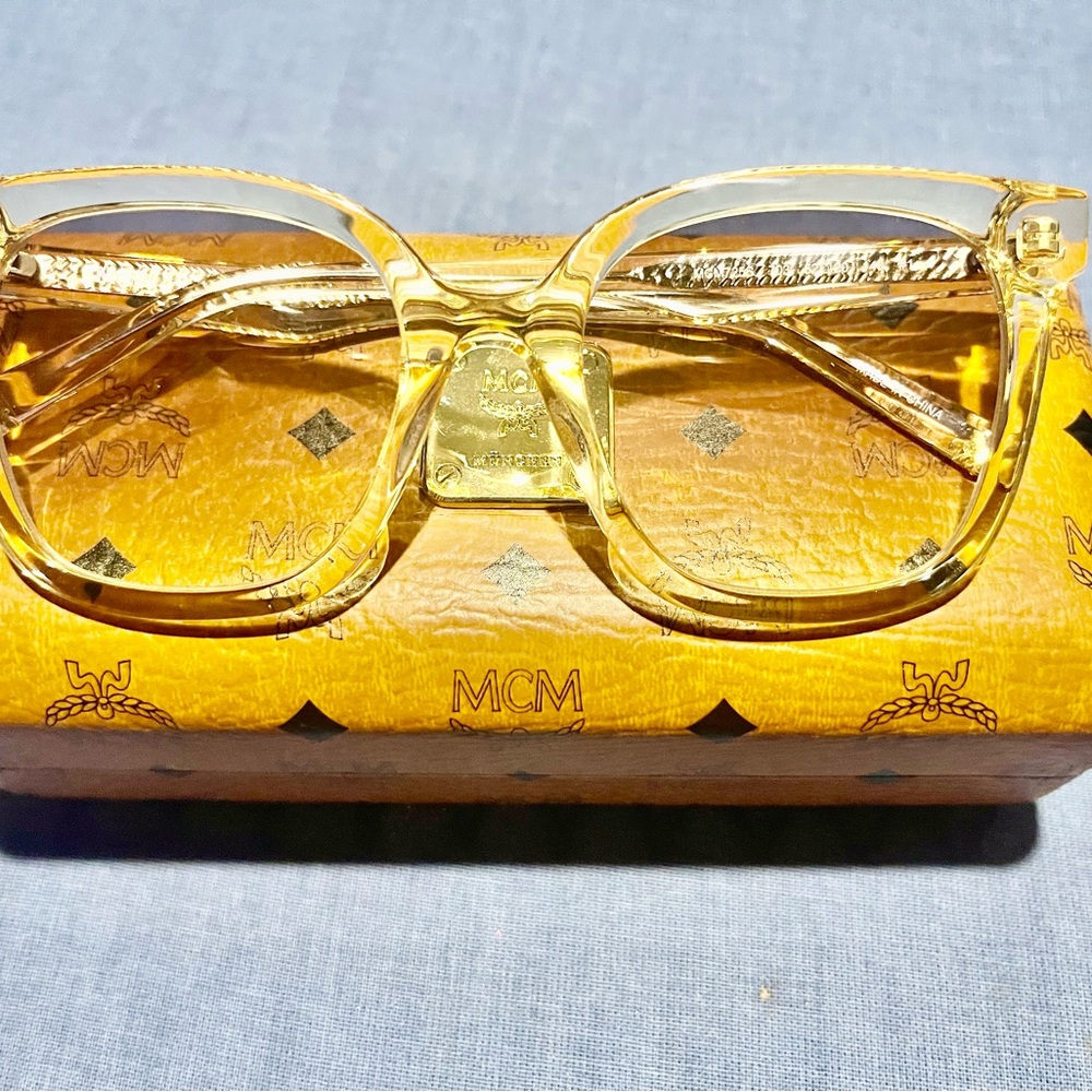 Brand new MCM sunglasses (gold/clear) with hard case.